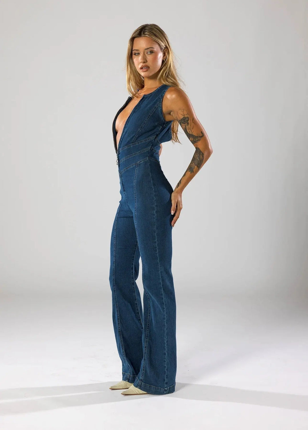 Duttini | Fitted Denim Jumpsuit with Plunge Neck and Flared Legs