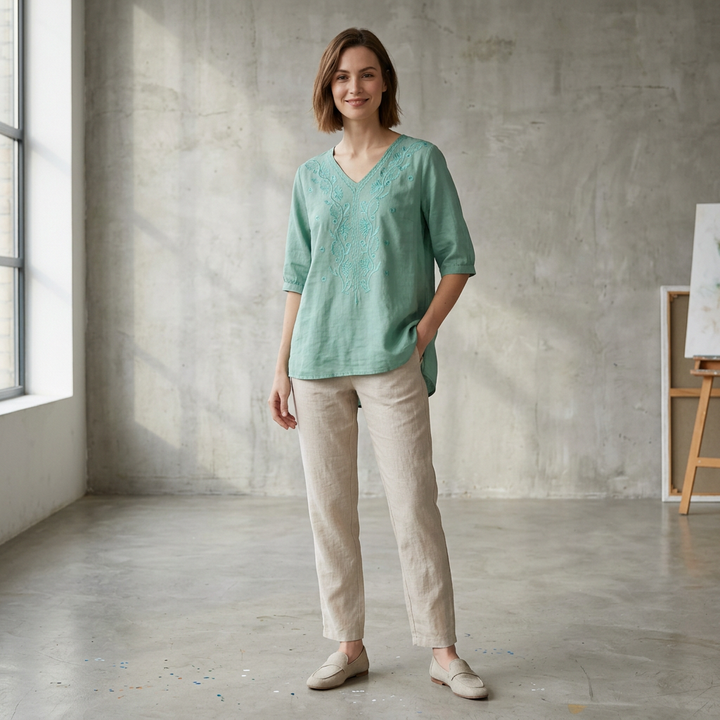 Duttini | Refined Relaxed V-Neck Blouse With Embroidered Floral Accents And High-Low Hem